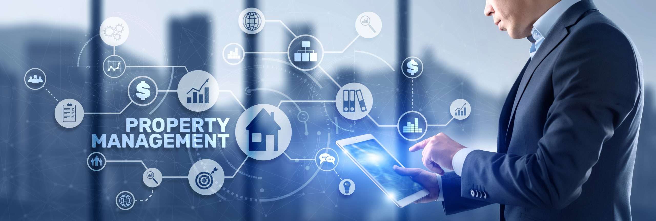 A man on a tablet looking at various aspects of property management including telecoms
