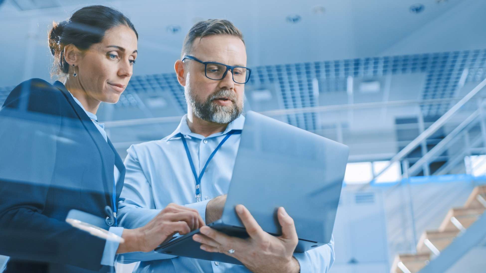 two people looking at a laptop